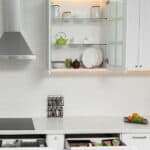 Open cabinets with different clean tableware and utensil